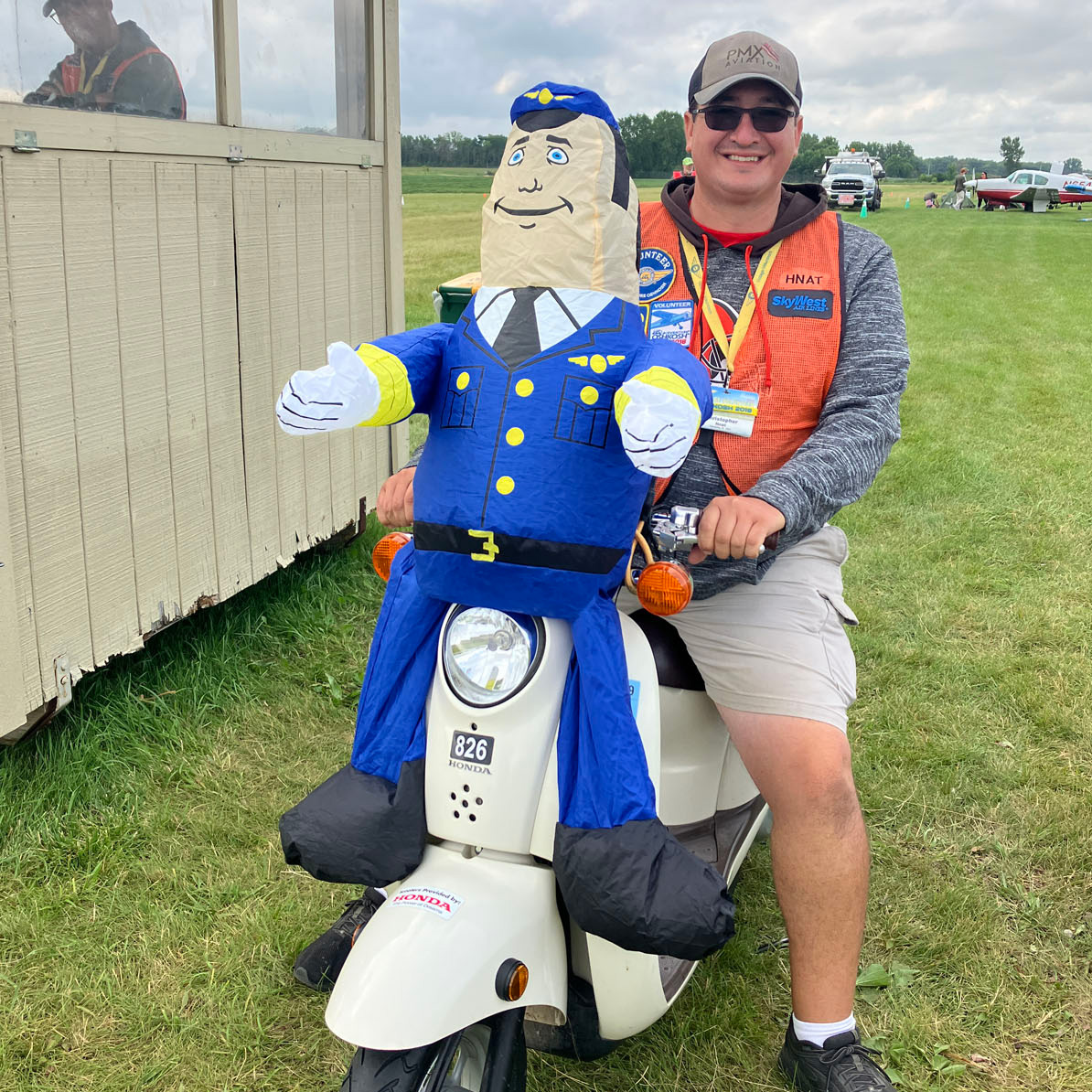 volunteer on moped with inflatable pilot 